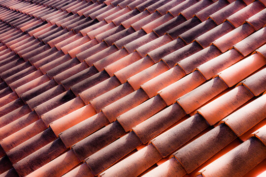 Repeating terracotta tiles on a roof in Italy