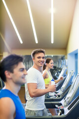 Fototapeta na wymiar Young people at treadmill