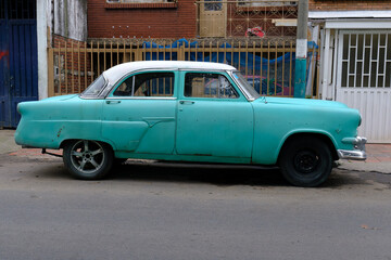 Faded Glory: Vintage North American Classic Car in Turquoise and White, Weathered but Timeless