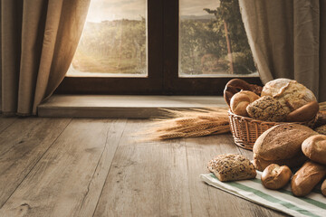 Fresh bread on the kitchen table in front of a window with a countryside panorama, healthy eating...