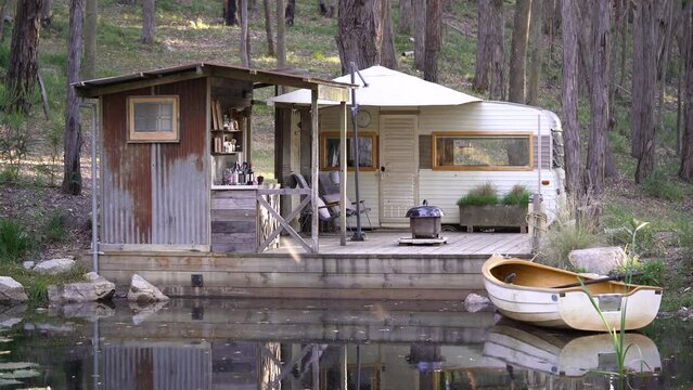Romantic and rustic cabin on a lake with a rowing boat, the perfect couples getaway (4K)