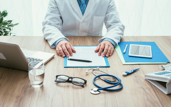 Professional doctor in his office working at desk, healthcare and hospitals concept