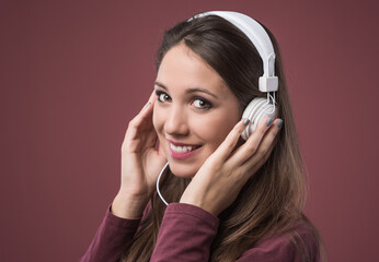 Smiling cheerful woman with white headphones