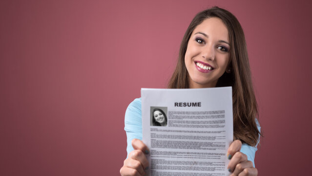 Young smiling woman holding her resume and applying for a job