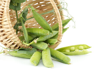 Basket with green peas pods isolated on white