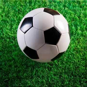 Soccer ball on green plastic artificial grass, soccer and sport concept.