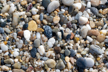Crushed stone on the seashore. Selective focus on object. The stones were laid on the ground in the garden as a background. Background blur. Pebble stones background.