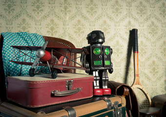 Fototapeta premium Assorted vintage items in the attic with retro wallpaper background.