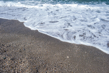 Sea waves run on the shore of the sea or ocean. Beautiful relaxing view on vacation.
