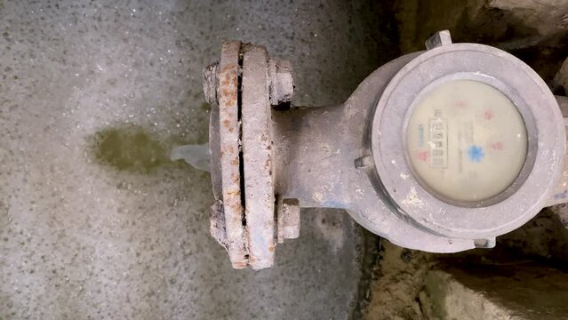 Dirty water coming out from the water meter pipe. Pouring water produce foam. Chemical waste water from industrial process. Wastewater Treatment Procedure (WWTP)