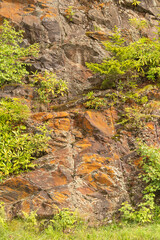 exposed stone on the side of the hill is visible as wind, weather, ice and running water erode away...