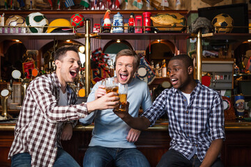 Smiling fans with a beer