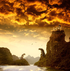 Obraz premium Beautiful fantasy landscape with the river, high mountains, storm sky, birds, old castle and giant stone statues of an eagle and a lion