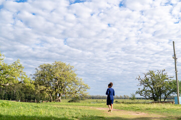 Woman walking outdoors in the field.