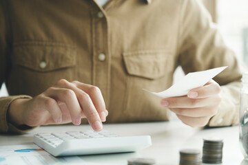 Accountant using calculator for calculate finance report in office.