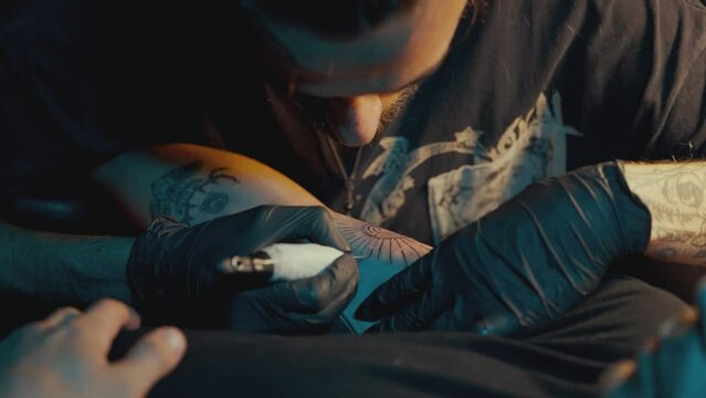 Hand-poke Tattoo Artist Working In His Studio - close up
