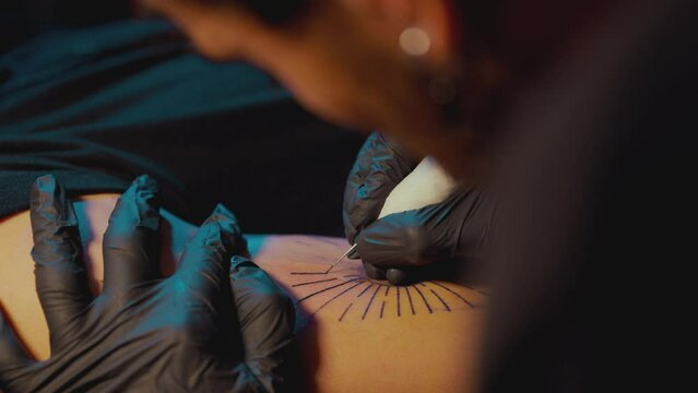 Tattoo Artist Makes A Tattoo On Man's Arm Using The Handpoke Method - close up