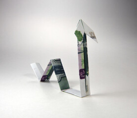 Arrow origami made of rubles bills on a white background