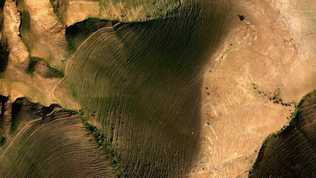Aerial Panning Shot Of People With Bikes On Hills During Sunny Day, Drone Flying Over Landscape - Nabi Musa, Israel