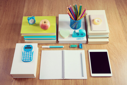 Perfectly tidy school student stationery on wooden surface.