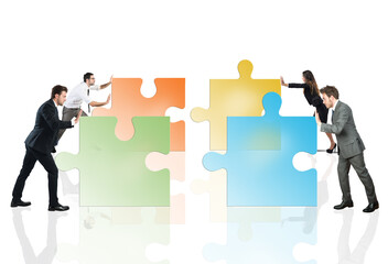 Concept of teamwork and partnership. Businesspeople pushing pieces of puzzle fit together.