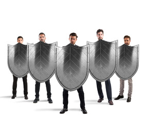 Businessmen with shields. concept of protection and defense in the business world