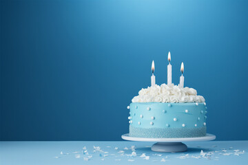 blue and white birthday cake and candles on black blue background