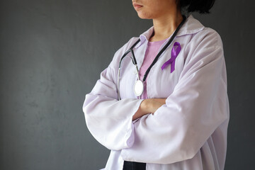 Side view of female doctor with purple ribbon on her chest as symbol of World Cancer Day