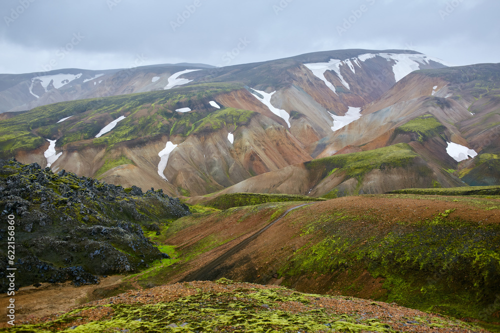 Sticker valley national park landmannalaugar. on the gentle slopes of the mountains are snow fields and glac