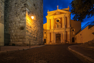 Antibes, France: beautiful medieval city in French Riviera between Cannes and Nice at night. Church...