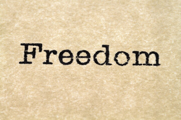 A close up image of the word "freedom" from a typewriter