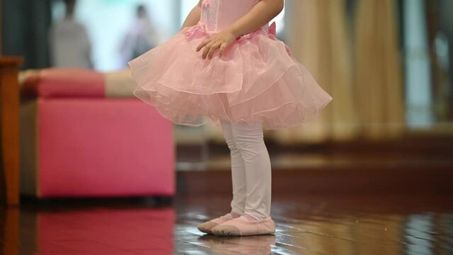 Girls dancers in ballet school learn to dance. Little Ballerinas in training in pink dancing suits. Children's ballet school. School of ballet.