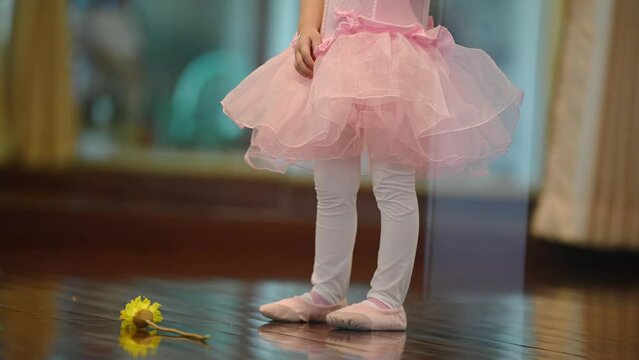 Girls dancers in ballet school learn to dance. Little Ballerinas in training in pink dancing suits. Children's ballet school. School of ballet.