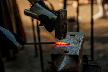 Hammering hot metal in forging process
