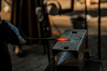 Hammering hot metal in forging process
