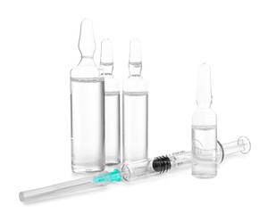 Medical ampules with syringe on white background
