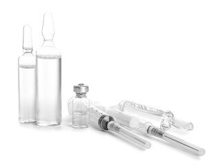 Medical ampules with syringes on white background