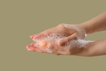 Fototapeta premium Hands with soap on color background