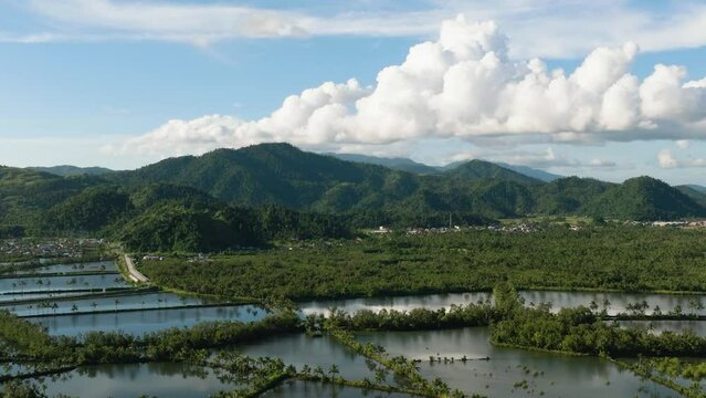 Agricultural farmland of fish in Surigao. Blue sky and clear clouds. Mindanao, Philippines