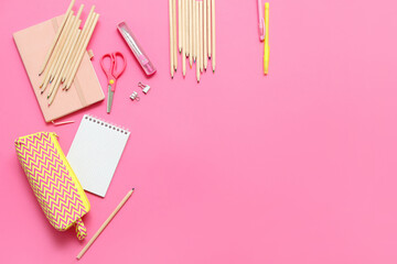 Notebooks and school stationery on pink background