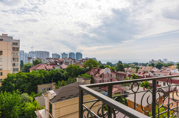 View of buildings and clouds from the balcony of a new residential building, panorama of a residential area