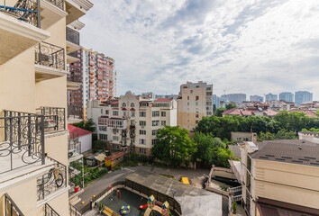 View of new houses from the apartment window, trees in the park, view from the window