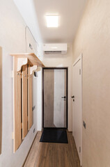 Interior design of a corridor with a clothes hanger and doors, rendering for a studio apartment