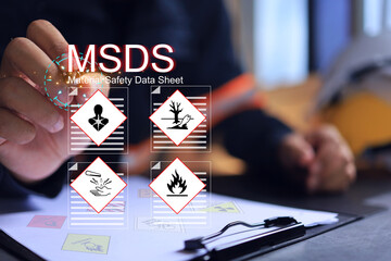 Safety officer writing on MSDS or material safety data sheet to indicate chemical information,...