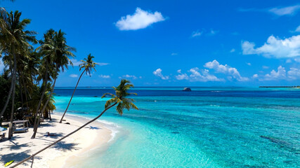 Obraz na płótnie Canvas The summer tropical on the sandy beach and turquoise Tropical beach with blue sky background