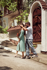 A couple in love met on the street in Italy. A beautiful slender girl and a young guy arranged a romantic date. The guy closes the girl's eyes. Love story, romance. The concept of travel, vacations