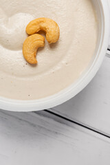 Cashew cream cheese with nuts and crackers, vegan dairy alternative