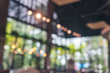 Blurred background cafe coffee shop restaurant in shopping mall with light bokeh business event...