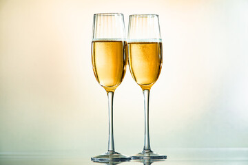 Minimalist image of two glasses of champagne with light tones