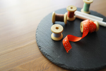 Old scissors, spools of colored thread, centimeter and tailors chalk, flat lay, concept of sewing clothes